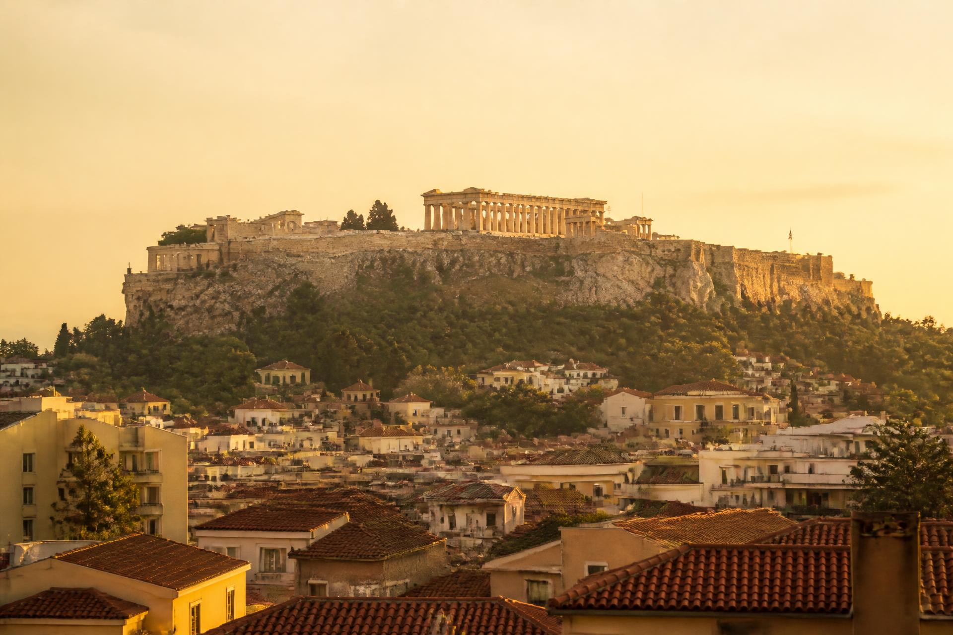 The Acropolis above the rooftops of Athens at golden hour